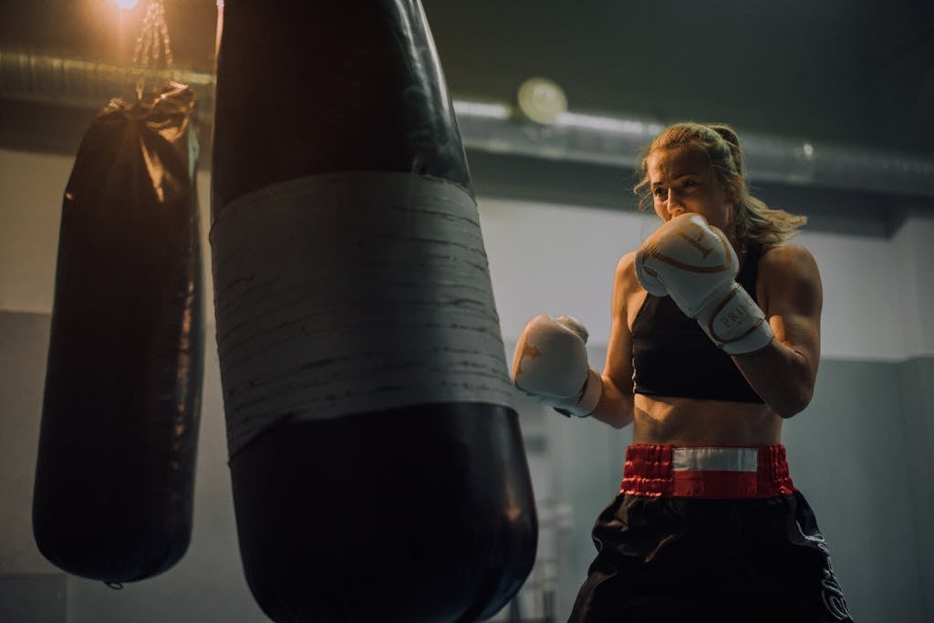 A Woman in Black Sports Bra Wearing a Boxing Gloves